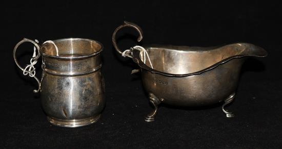 A silver sauceboat and mug.